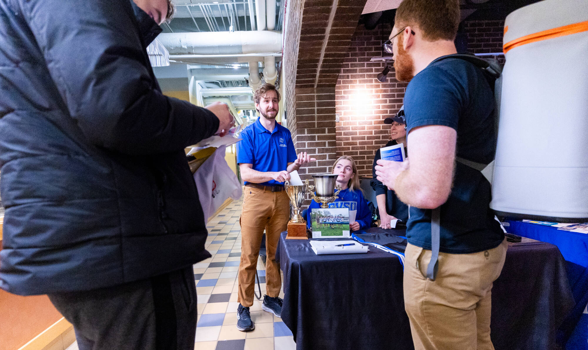 Student talking about their organization to another student.